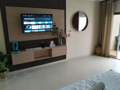 a living room with a flat screen tv on a wall at Luxury Apartment Agdal, Ideal for CAN 2025 Fans in Rabat