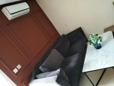 a living room with a black chair and a table at Luxury Apartment Agdal, Ideal for CAN 2025 Fans in Rabat