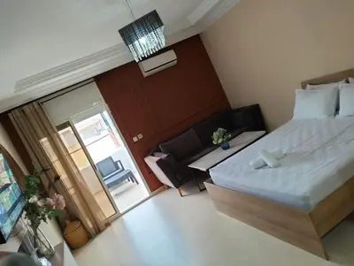 a bedroom with a bed and a sliding glass door at Luxury Apartment Agdal, Ideal for CAN 2025 Fans in Rabat