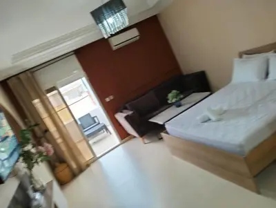 a small bedroom with a bed and a sliding glass door at Luxury Apartment Agdal, Ideal for CAN 2025 Fans in Rabat