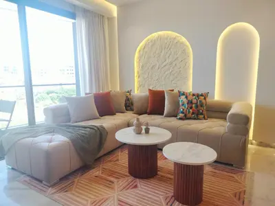 a living room with a couch and two tables at Luxury Stay in Casablanca in Maarif
