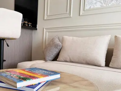 a stack of books on a coffee table on a couch at Zenata Luxury Stay in Aïn Harrouda