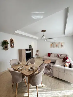 a living room with a table and a couch at VIVASTAY Casablanca - Zenata eco city beach access with swimming pool in Aïn Harrouda