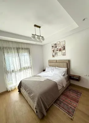 a bedroom with a large bed and a window at VIVASTAY Casablanca - Zenata eco city beach access with swimming pool in Aïn Harrouda