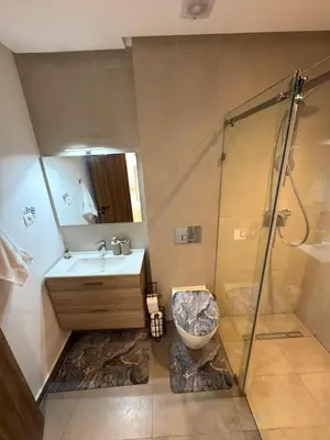 a bathroom with a sink and a shower and a toilet at VIVASTAY Casablanca - Zenata eco city beach access with swimming pool in Aïn Harrouda