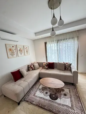a living room with a couch and a table at VIVASTAY Casablanca - Zenata eco city beach access with swimming pool in Aïn Harrouda
