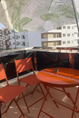 a table and two chairs on a roof at Najia Blue Pearl in Sidi Rahal