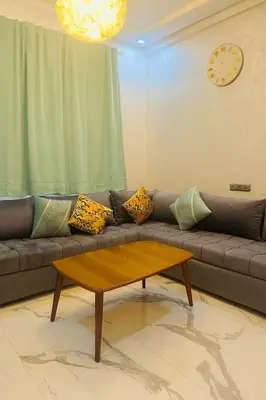a living room with a couch with a coffee table at Najia Blue Pearl in Sidi Rahal