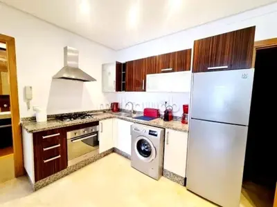 a kitchen with a white refrigerator and a dishwasher at A Comfortable Escape In Morocco in Casablanca