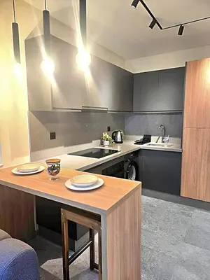 a kitchen with a counter and a table with plates on it at Casablanca METROPOL Urban Luxury Loft in Casablanca
