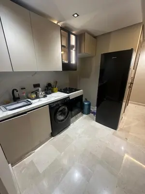 a kitchen with a washing machine and a washer at Studio Neuf in Casablanca