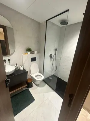 a bathroom with a shower and a toilet and a sink at Studio Neuf in Casablanca