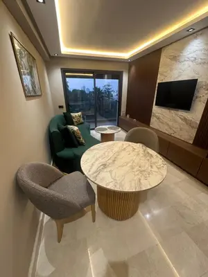 a living room with a couch and a table and chairs at Studio Neuf in Casablanca