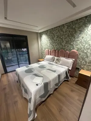 a bedroom with a large bed with a blanket at Studio Neuf in Casablanca