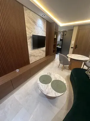a living room with a table and a tv at Studio Neuf in Casablanca