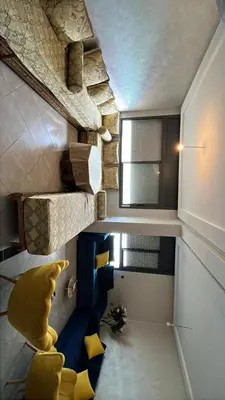 a small room with a bed and a window at Appartement duplexe convivial in Bouznika