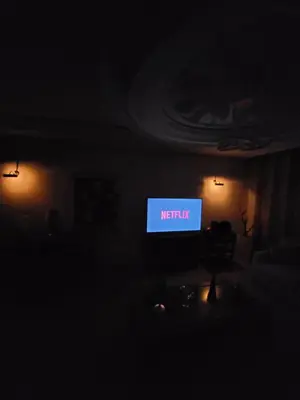a television in a dark room with a sign that reads netflix at Appartement chic de 3 chambres au cœur de Casablanca in Casablanca