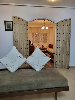 two pillows sitting on a bench in a living room at Appartement chic de 3 chambres au cœur de Casablanca in Casablanca