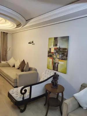 a living room with a couch and a table at Appartement chic de 3 chambres au cœur de Casablanca in Casablanca