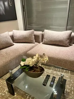 a living room with a couch and a glass table at residence socrate in Casablanca