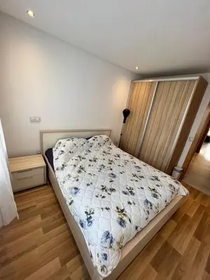 a bedroom with a bed with a floral comforter at Appartement confortable in Maarif