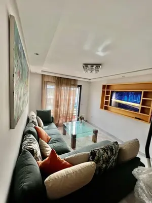 a living room with a couch and a glass table at Appartement confortable in Maarif