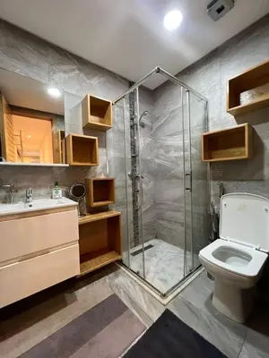 a bathroom with a shower and a toilet and a sink at Appartement confortable in Maarif