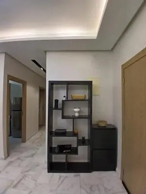 a room with a shelf in the middle of a room at Cozy 2-bedroom apartment, pool view with beach access a Zenata City Eco Casablanca in Oulad Akkou