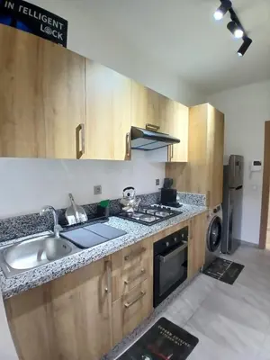 a kitchen with a sink and a stove at Cozy 2-bedroom apartment, pool view with beach access a Zenata City Eco Casablanca in Oulad Akkou