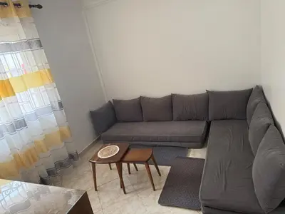 a living room with a couch and a table at relaxing apartment in Bouznika in Bouznika