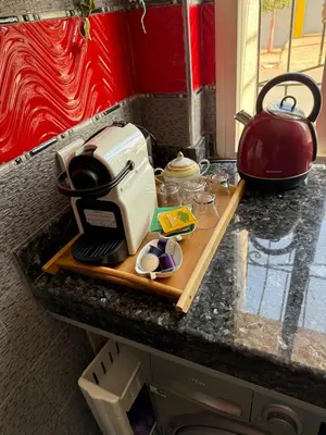 a kitchen counter with a toaster and a tea kettle at relaxing apartment in Bouznika in Bouznika