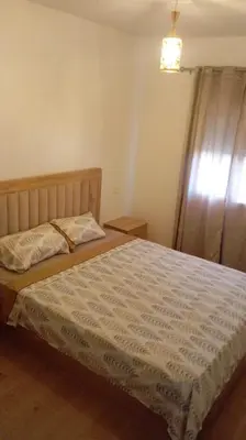 a bedroom with a large bed with a window at T3 Moderne proche Ocean in Rabat