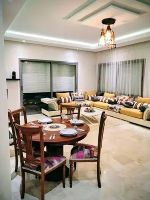 a living room with a table and chairs and a couch at Moroccan Sunset - Charming 3BR near Airport Med 5 in Nouaseur