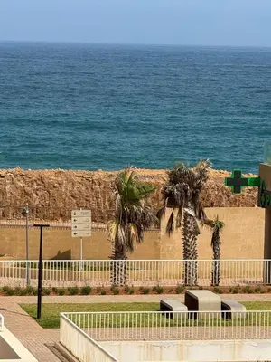 two palm trees in front of the ocean at Rabat Atlantic Océan in Rabat
