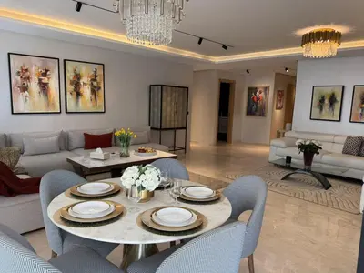 a living room with a table and a couch at Rabat Atlantic Océan in Rabat