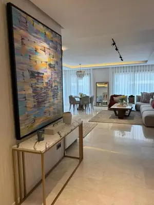a living room with a large painting on the wall at Rabat Atlantic Océan in Rabat