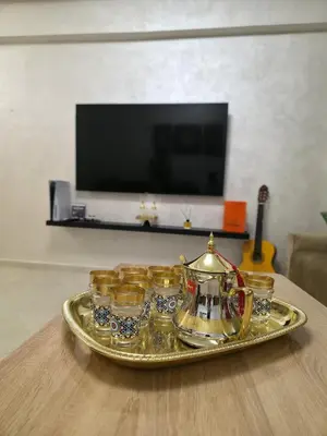 a tray with cups and a tea kettle on a table at appartement luxe dt5 in Mohammedia