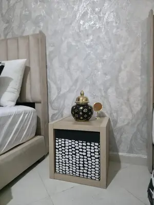 a bedroom with a bed and a urn on a table at appartement luxe dt5 in Mohammedia