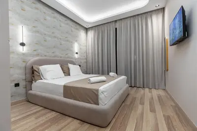 a bedroom with a large bed and a wall at Luxury Studio Apartment - Maarif Near CFC & Downtown in Casablanca