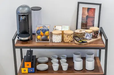 a shelf with a coffee maker and cups on it at Luxury Studio Apartment - Maarif Near CFC & Downtown in Casablanca