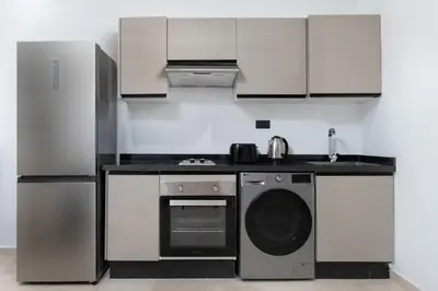 a kitchen with a stove and a dishwasher at Luxury Studio Apartment - Maarif Near CFC & Downtown in Casablanca