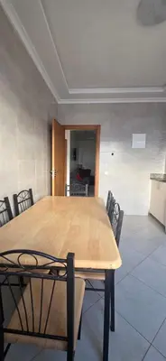 a wooden table and chairs in a room at luxury apartment DT2 in Mohammedia