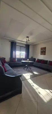a living room with a couch and a table at luxury apartment DT2 in Mohammedia