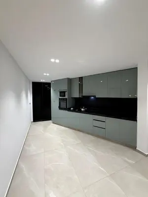 a large kitchen with white cabinets and a tile floor at Apartment in Rabat Ocean Absolute Refinement in Rabat