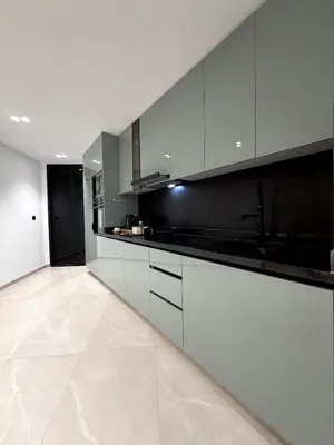 a kitchen with white cabinets and black counter tops at Apartment in Rabat Ocean Absolute Refinement in Rabat