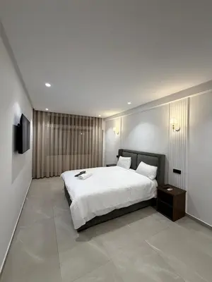 a bedroom with a large white bed and a television at Apartment in Rabat Ocean Absolute Refinement in Rabat