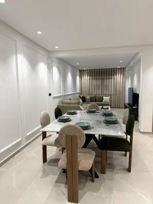 a dining room with a table and a couch at Apartment in Rabat Ocean Absolute Refinement in Rabat
