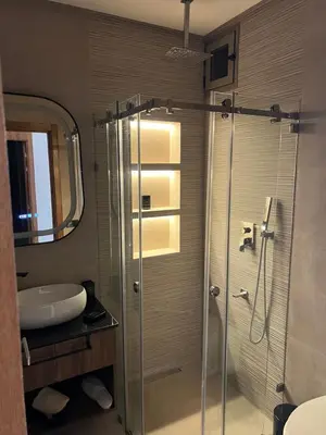a bathroom with a glass shower with a sink at Appartamento di lusso nel cuore di Rabat in Rabat