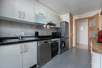 a kitchen with a sink and a dishwasher at Luxury 2BR Pearl of Agdal Near Agdal Train Station in Rabat