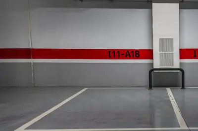 an empty parking garage with a red and white wall at Luxury 2BR Pearl of Agdal Near Agdal Train Station in Rabat